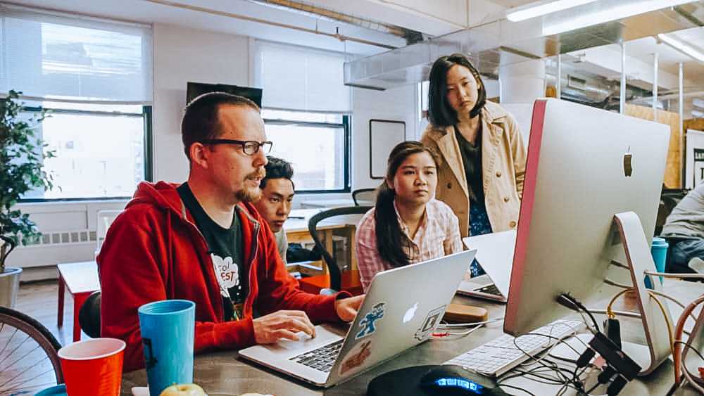 three students looking at a monitor